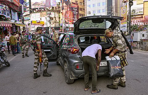 Security officials check a vehicle ahead of the Bihar Assembly Election 2025, in Patna, Bihar, Saturday, Oct. 11, 2025.