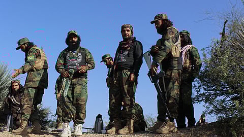 Afghan servicemen guard along the border in the Zazai Maidan district of Khost province, Afghanistan, Sunday, Oct. 12, 2025, after overnight clashes with Pakistan's forces.
