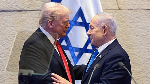 President Donald Trump talks with Israel's Prime Minister Benjamin Netanyahu at the Knesset, Israel's parliament, Monday, Oct. 13, 2025, in Jerusalem.