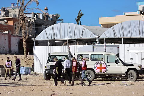 Red Crescent vehicles and refrigerated trucks, transporting the bodies of 45 Palestinians that had been in Israeli custody, arrive at the Nasser hospital in Khan Yunis in the southern Gaza Strip on October 14, 2025.
