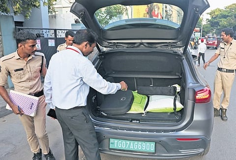With the MCC in force, officials check a vehicle at Srinagar Colony on Tuesday.