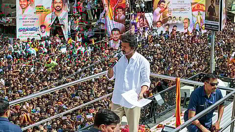 In this image from Sep. 27, 2025, Tamilaga Vettri Kazhagam chief and actor Vijay addresses a gathering before a stampede during a public event, in Karur.