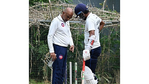 Coach Amay Khurasiya with a Kerala player