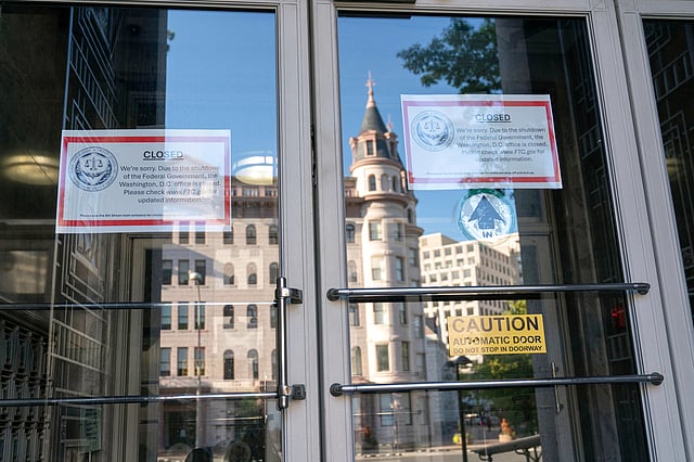 Signs that read, "We're sorry. Due to the shutdown of the Federal Government, the Washington, DC office is closed." is seen on the doors of the Federal Trade Commission building on the sixth day of the government shutdown in Washington, Monday, Oct. 6, 2025.