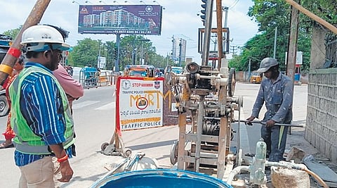 Agency workers collect soil samples for geotechnical investigation at the site of the proposed elevated corridor