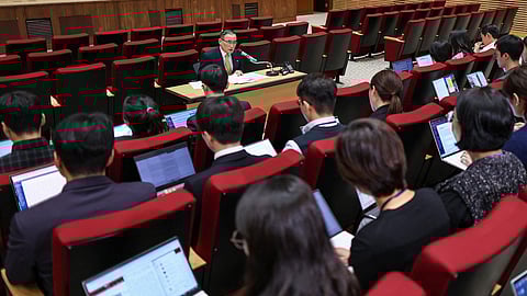 South Korea's National Security Advisor Wi Sung-lac (C, top) speaks during a press conference at the Presidential Office in Seoul on October 15, 2025.