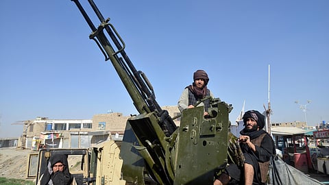 Armed Taliban security personnel operating an anti-aircraft gun watch the sky for Pakistani airstrikes during ongoing clashes between Taliban security personnel and Pakistani border forces in the Spin Boldak district of Kandahar Province on October 15,2025.