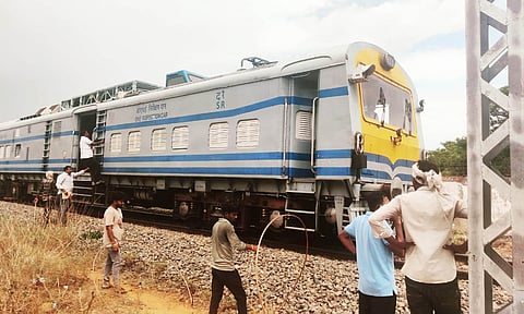 Railway staff carrying out maintenance works in electric lines near Uchipuli after the train's pantograph got entangled with overhead wires on Monday.