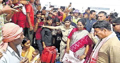 In this image posted on Oct. 14, 2025, Delhi Chief Minister Rekha Gupta interacts with passengers during her visit to the New Delhi Railway Station.