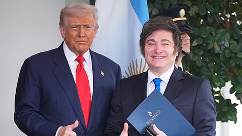 US President Donald Trump (L) greets Argentina's President Javier Milei (R) as he arrives at the White House, Tuesday, Oct. 14, 2025, in Washington.