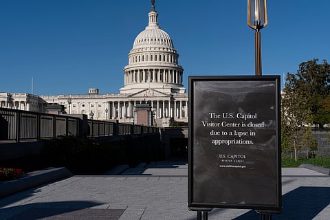 With the government shutdown now in its third week, a sign turns away tourists at the entrance to the Capitol Visitor Center in Washington, Wednesday, Oct. 15, 2025.