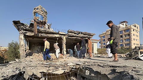 Residents remove debris from a house damaged by Wednesday's two drone strikes in Kabul, Afghanistan, Thursday, Oct. 16, 2025.