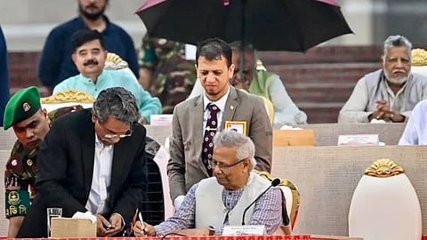 Muhammad Yunus (front C), Chief Adviser of Bangladesh's Interim Government and Head of the National Consensus Commission, signs the July National Charter in Dhaka on October 17, 2025.