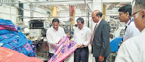 In happier times: File picture of The Kakatiya Weavers Cooperative Society of Textile Park powerloom unit workers at Madikonda in Hanamkonda