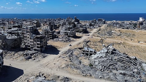 In this drone photo, buildings destroyed during two years of Israeli army bombardments are seen near the seashore in Gaza City, Wednesday, Oct. 15, 2025.