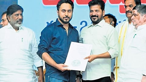 Chief Minister A Revanth Reddy hands over an appointment letter to a candidate as ministers Mallu Bhatti Vikramarka and Ponnam Prabhakar