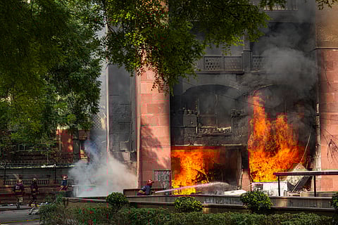 Firefighters try to douse a fire that broke out at Brahmaputra Apartments, in New Delhi, Saturday, Oct. 18, 2025. The apartment complex houses residences of several Lok Sabha and Rajya Sabha MPs.