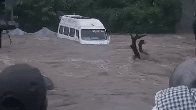 A traveller van being washed away