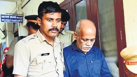 Chenthamara being escorted back to prison following the verdict on Saturday