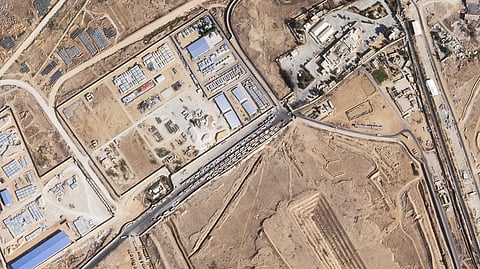 This satellite photo from Planet Labs PBC shows trucks lined up on the Egyptian side of the Rafah border crossing with the Gaza Strip on Thursday, Oct. 16, 2025.