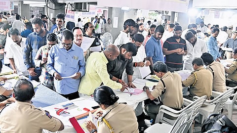 Officials receive tender applications on the last day for wine shops in Telangana at Prohibition and Excise office Nampally in Hyderabad on Saturday