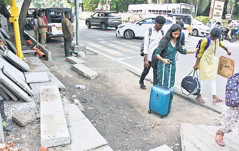 Footpaths on Sardar Patel Road have been reduced to half to make way for road widening by the highways, making them inaccessible for pedestrians