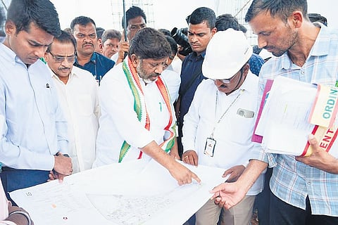 Deputy Chief Minister Mallu Bhatti Vikramarka reads the construction map of the Young India Integrated Residential School in Lakshmipuram village, Bonakallu mandal of Madhira constituency