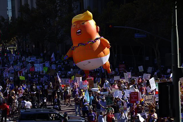 Pulling a giant inflatable Donald Trump protesters march in the streets during a "No Kings" protest Saturday, Oct. 18, 2025, in Los Angeles.