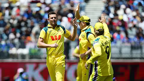 Australia's Josh Hazlewood celebrates with teammates after taking the wicket of India's Rohit Sharma.