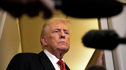 US President Donald Trump speaks to reporters aboard Air Force One, Sunday, Oct. 19, 2025, en route to Joint Base Andrews, Md., as he returns from a trip to Florida