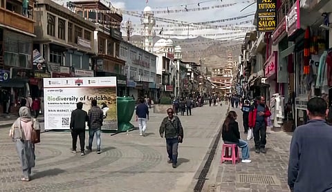 In this Oct. 3, 2025, photo, people walk through a market in Leh as curfew relaxations continue following days of unrest.