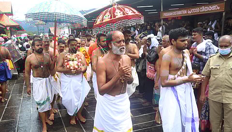 Thantri Kandararu Mahesh Mohanaru leading the procession carrying the brahmakalasam as part of the kalabhabhishekam ritual at Sabarimala on Sunday.