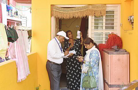 An enumerators collects details from a family as part of the socio-economic survey at Bapujinagar, in Bengaluru.