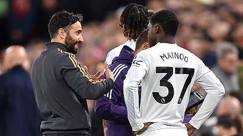 Manchester United's Portuguese head coach Ruben Amorim talks to Manchester United's English midfielder Kobbie Mainoo during the EPL football match between Liverpool and Manchester United at Anfield in Liverpool, north west England on October 19, 2025.