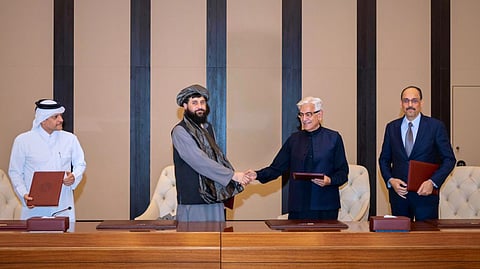 Pakistani Defence Minister Khawaja Asif, center right, and Afghan Defence Minister Mullah Muhammad Yaqoob shake hands after signing a ceasefire agreement in Doha, Qatar, Sunday, October 19, 2025.