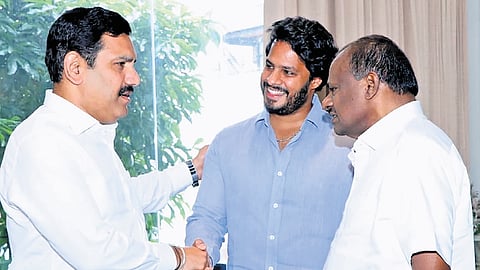 BJP state president BY Vijayendra greets Union minister HD Kumaraswamy and his son and JDS Youth Wing president Nikhil Kumaraswamy in Bengaluru on Tuesday.