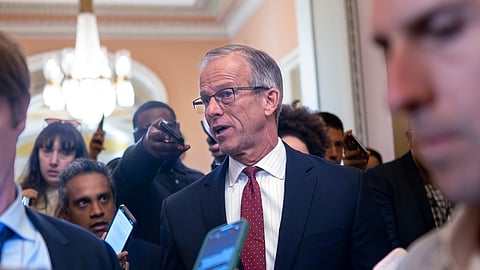 Senate Majority Leader John Thune, R-SD, pauses in his office doorway to speak to reporters on day 20 of the government shutdown at the Capitol in Washington, Monday, Oct. 20, 2025.