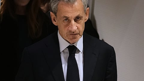 FILE- Former French President Nicolas Sarkozy leaves after a Paris court sentenced him to 5 years after finding him guilty of criminal conspiracy in an alleged scheme to finance his 2007 campaign with funds from Libya, Thursday, Sept. 25, 2025 in Paris.