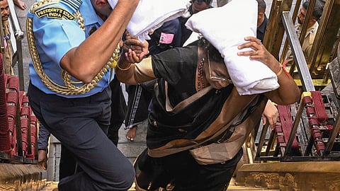 President Droupadi Murmu climbs the 18 holy steps at Sabarimala temple on Wednesday. She is the second Indian President, and the first woman head of state, to visit the hill shrine.