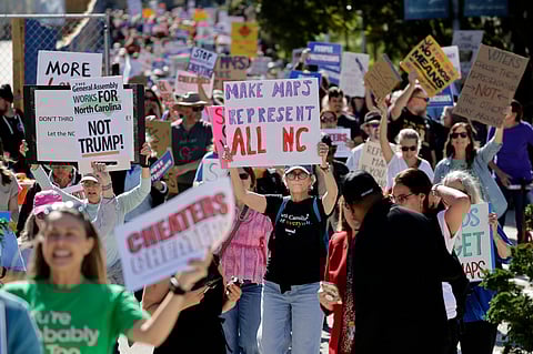 Marchers proceed from the Capitol during a rally protesting a proposed redistricting map Tuesday, Oct. 21, 2025, in Raleigh, N.C.