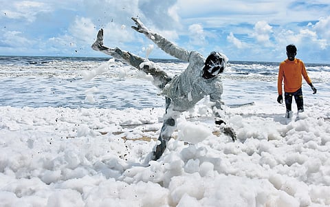 Boys play in the thick white froth that covered 1.5 km of Chennai’s coastline between Pattinapakkam and Srinivasapuram on Wednesday.