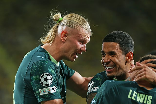 Manchester City's Erling Haaland, left, celebrates with teammates after scoring his side's opening goal during the Champions League opening phase football match between Villarreal and Manchester City in Villarreal, Spain, Tuesday, Oct. 21, 2025.