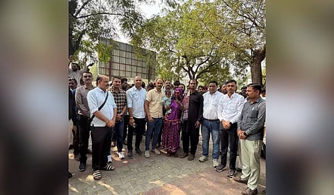 Police officials with six-month-old baby