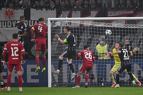 Liverpool's Dutch defender #04 Virgil van Dijk (2nd L) scores the 1-2 goal with his head during the UEFA Champions League football match between Eintracht Frankfurt and Liverpool FC in Frankfurt, western Germany on October 22, 2025.