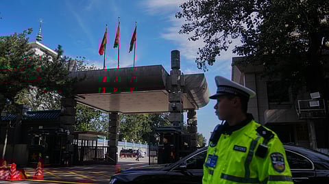 Chinese security personnel stand guard at the entrance to the Jingxi Hotel where the Communist Party's Central Committee is holding its fourth plenum, in Beijing, Monday, Oct. 20, 2025.