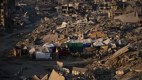 Tents for displaced Palestinians stand amid the destruction caused by the Israeli air and ground offensive in the Sheikh Radwan neighborhood in Gaza City, Wednesday, Oct. 22, 2025.