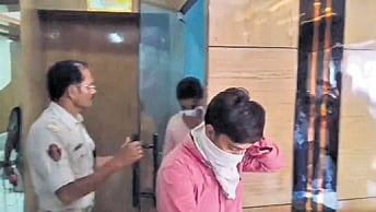 Police arresting the accused from the hotel in Cuttack
