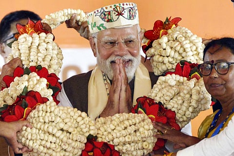 Prime Minister Narendra Modi being garlanded during a public meeting ahead of the state Assembly elections, in Samastipur district, Friday, Oct. 24, 2025.