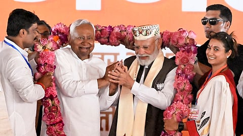 Prime Minister Narendra Modi and Bihar Chief Minister Nitish Kumar being garlanded during a public meeting ahead of the state Assembly elections, in Samastipur district, Friday, Oct. 24, 2025
