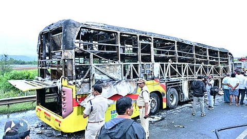 Police personnel investigate the spot after a Hyderabad-bound private bus caught fire following a collision with a two-wheeler, near Chinnatekur in Kurnool district, Andhra Pradesh, Friday, Oct. 24, 2025.